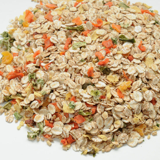 Muesli mix with oats, dried fruits, and nuts on a white background