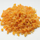 Pile of orange dried fruit on a white background